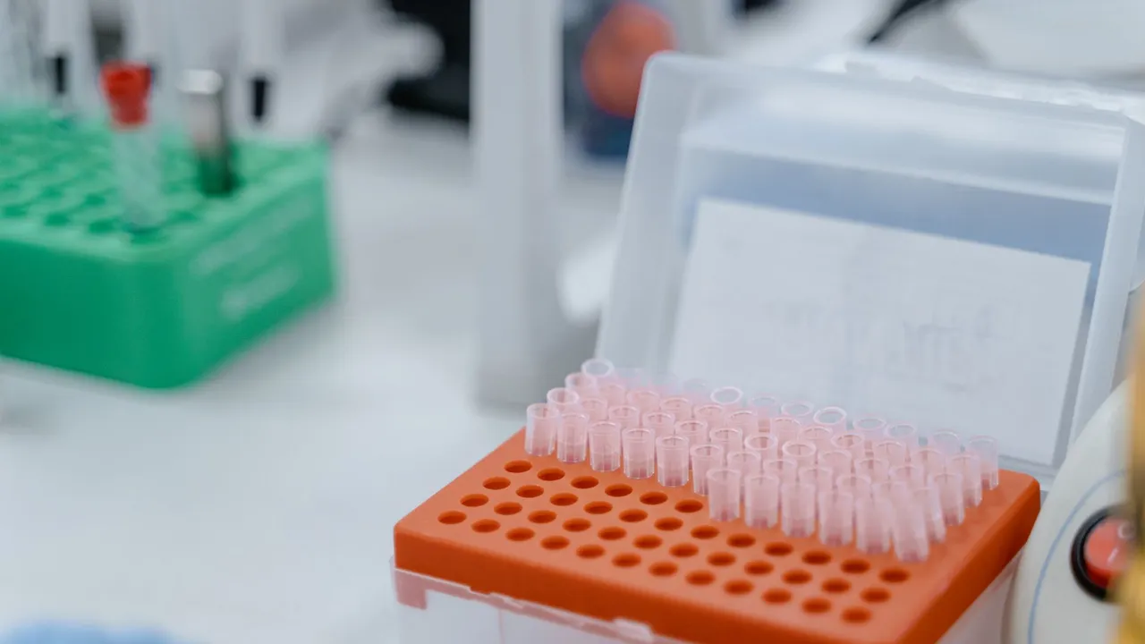 Close-up of laboratory equipment featuring test tube rack with scientific instruments.