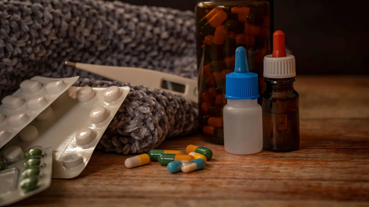 Collection of flu remedies including pills, thermometer, and scarf for winter cold relief.