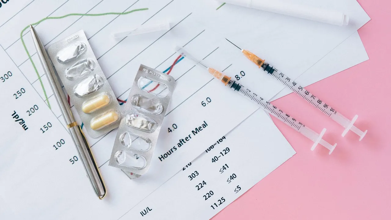 Flat lay of medicines, syringes, and a blood glucose chart on a pink surface, representing health management.