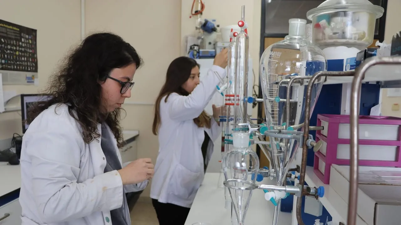 Scientists in a chemistry lab conducting experiments with precision.