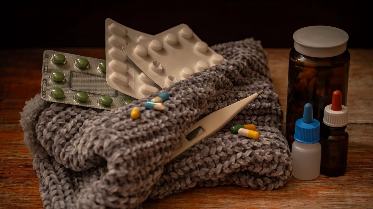 A collection of home remedies for colds and flu including pills, thermometer, and medicine bottles.