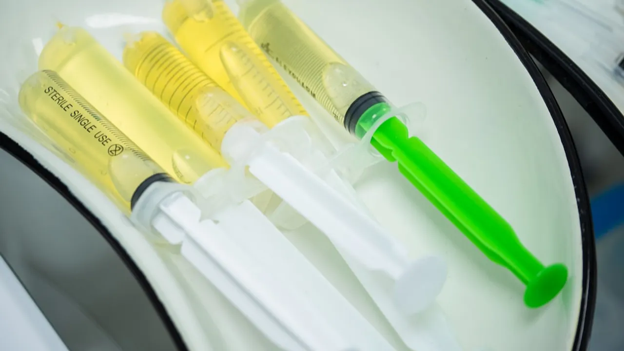 Syringes filled with yellow liquid ready for use