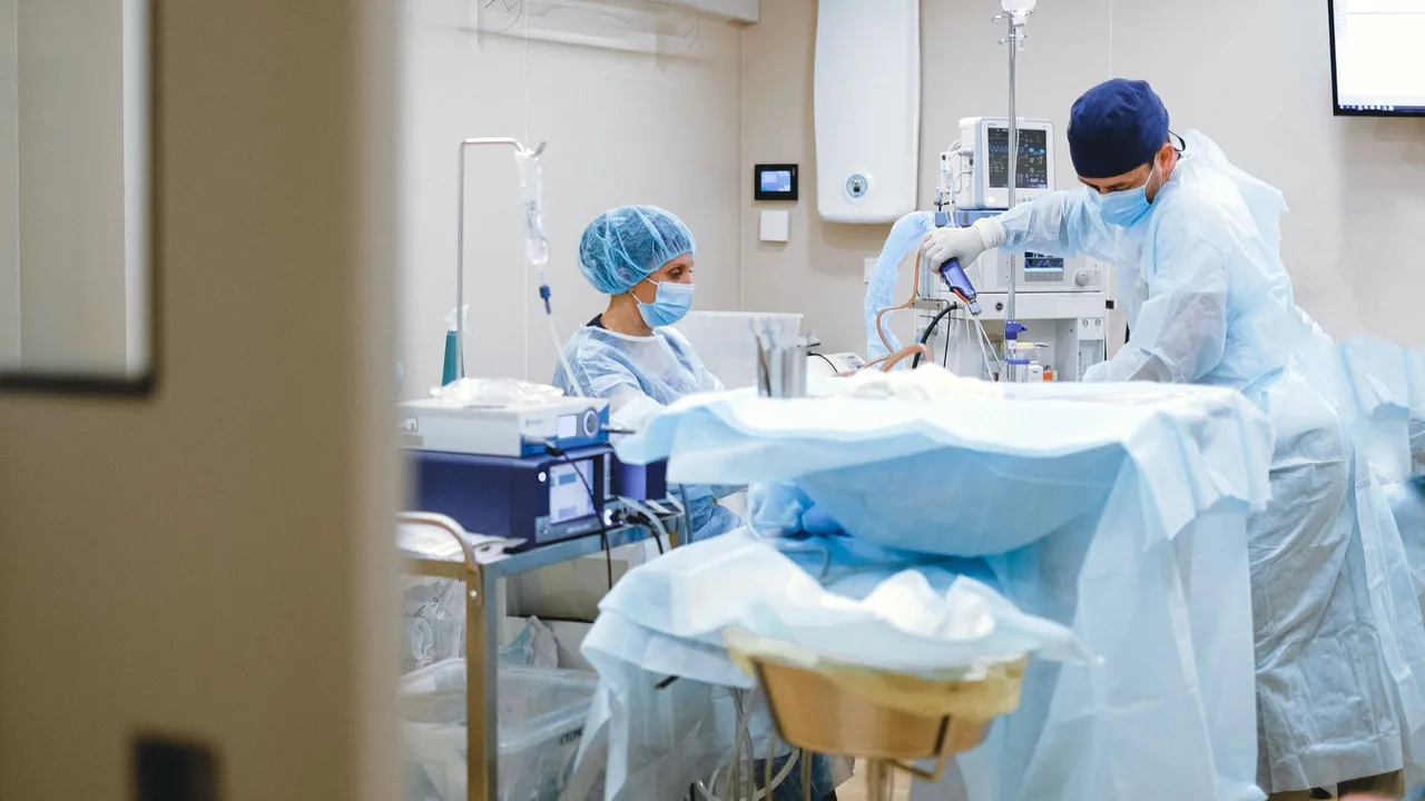Surgeons and medical staff in a sterile operating room conducting a surgical procedure.