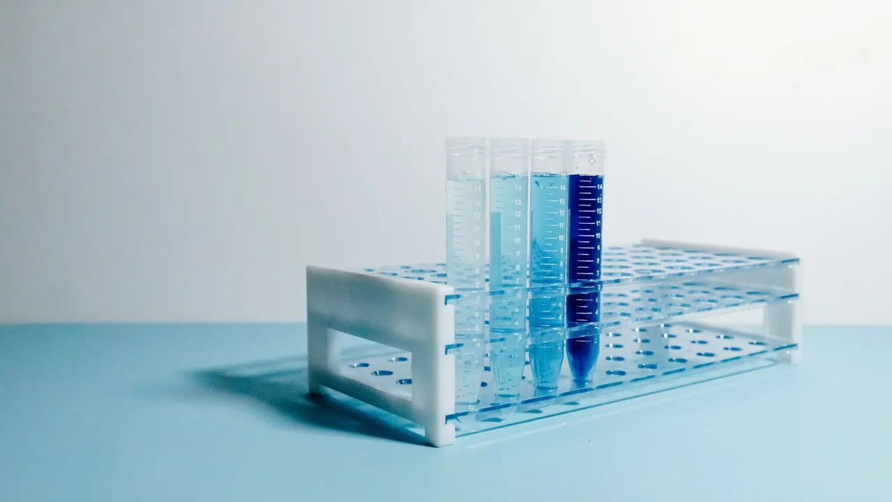 A minimalist arrangement of test tubes on a blue surface, perfect for science and laboratory themes.
