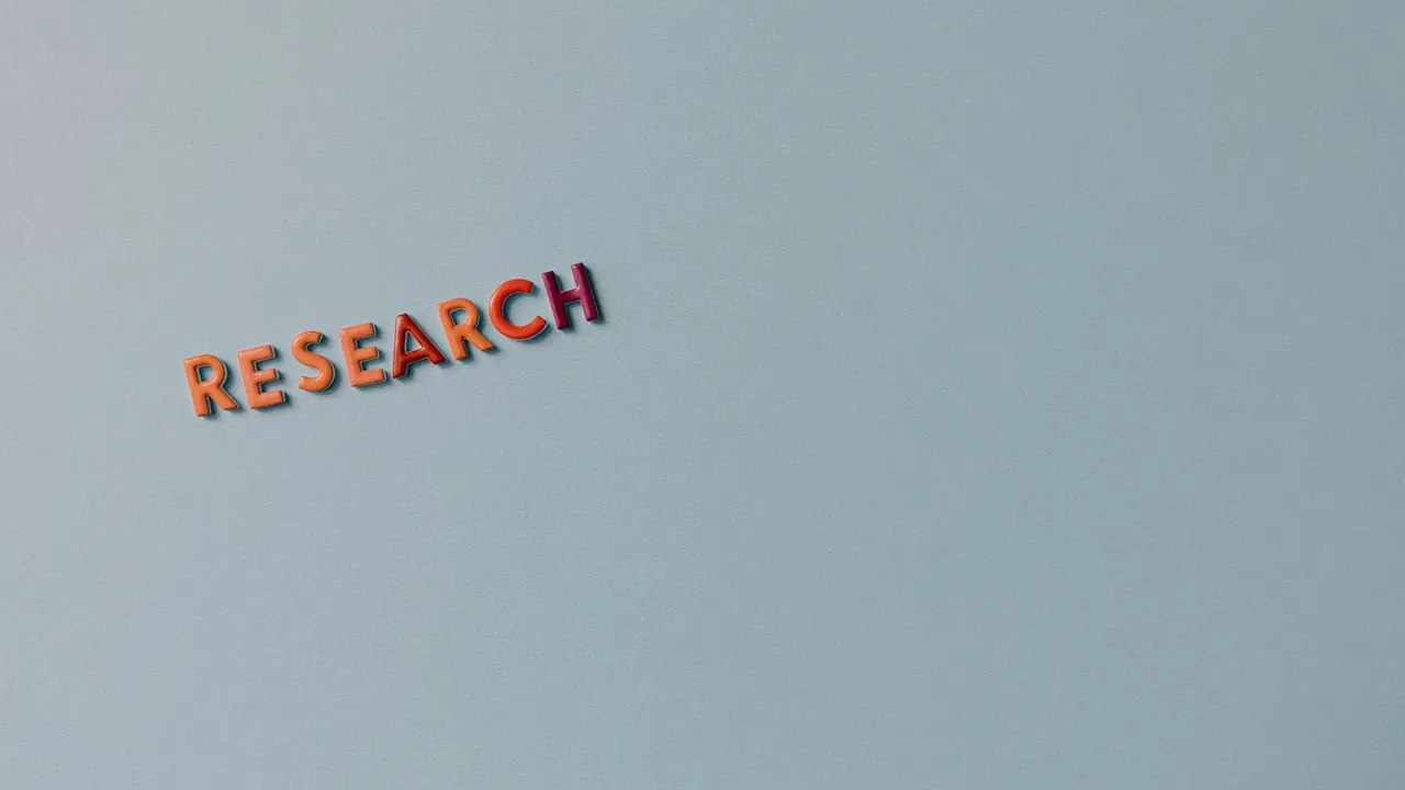 Minimalist image with the word 'RESEARCH' in colorful letters on a plain background.