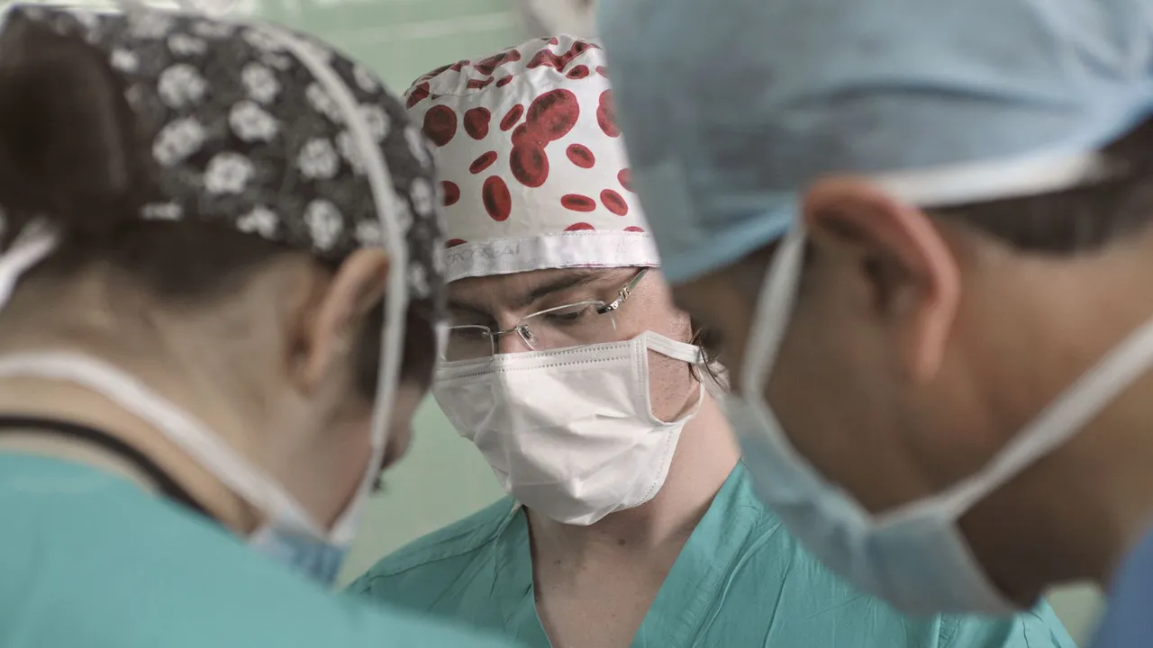 Surgeons wearing masks and scrubs collaborate during a medical operation in an operating room.