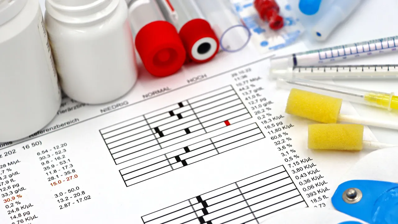 Arrangement of medical equipment, lab tests, and health data on a clinical table.