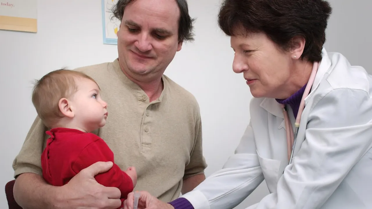 a doctor examines a baby's chest with a stethoscope