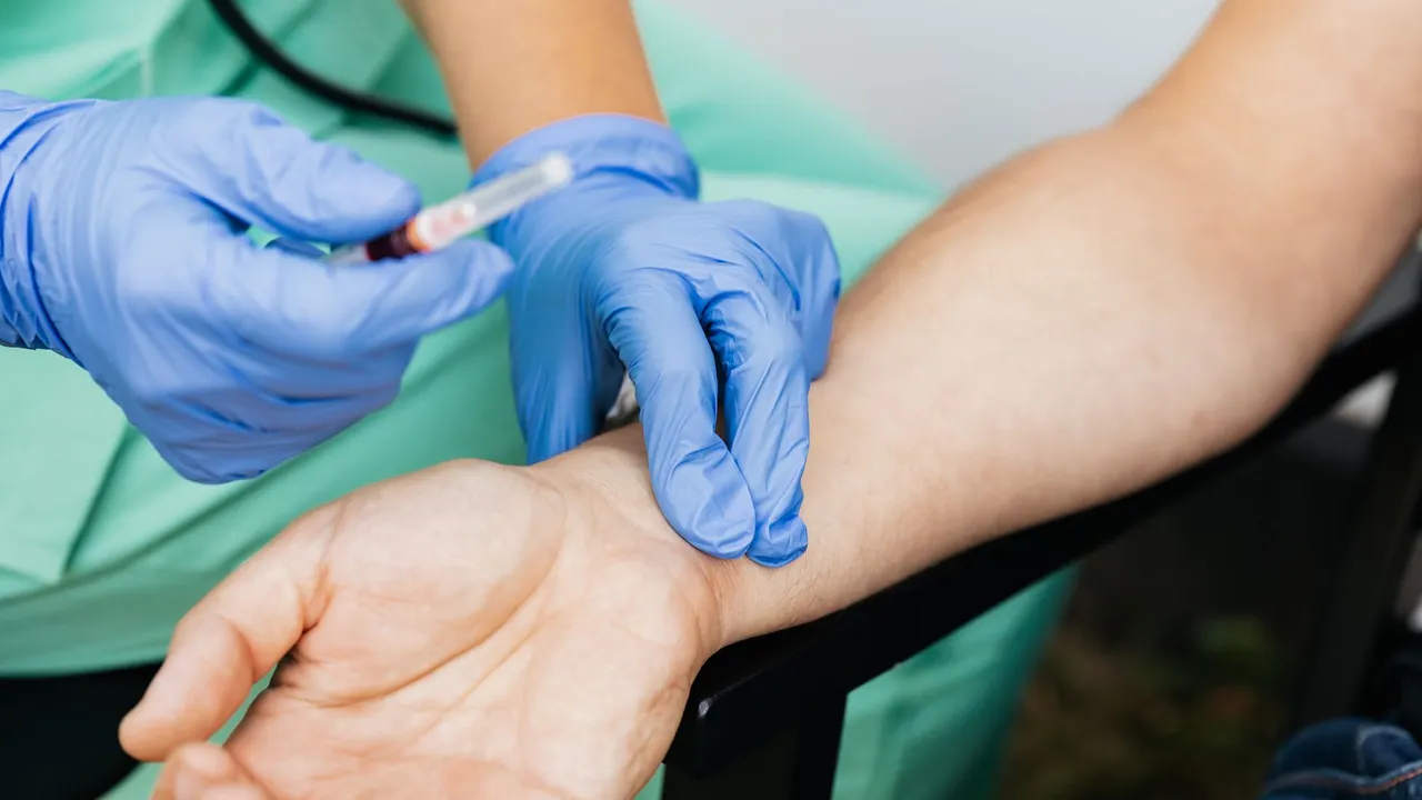 Close-up of nurse checking pulse and preparing syringe for medical use.