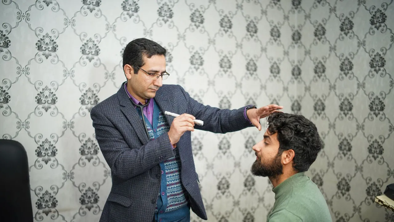 A doctor performs an eye examination on a patient in a clinical setting.
