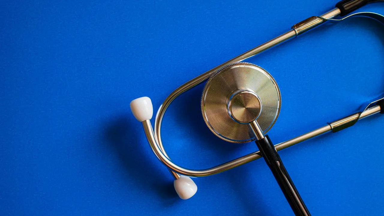 Stethoscope on blue background symbolizing healthcare and medical diagnosis.