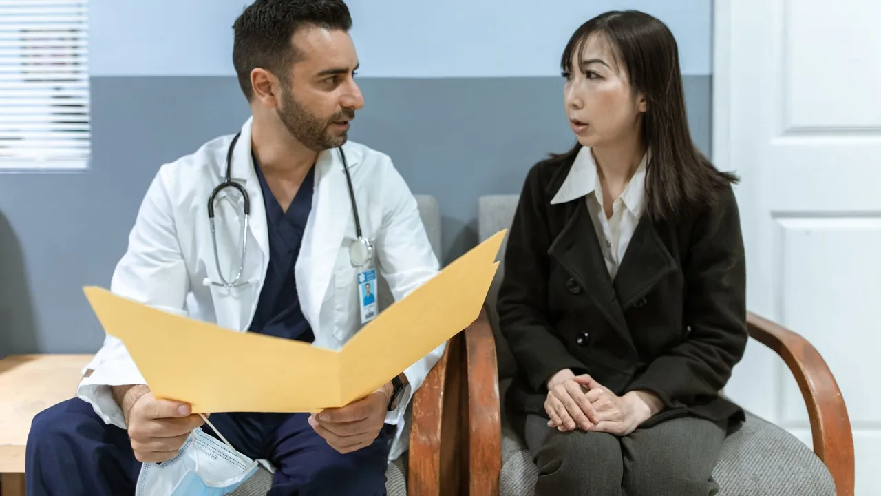 Healthcare professional consults patient in clinical setting. Medical discussion and diagnosis.