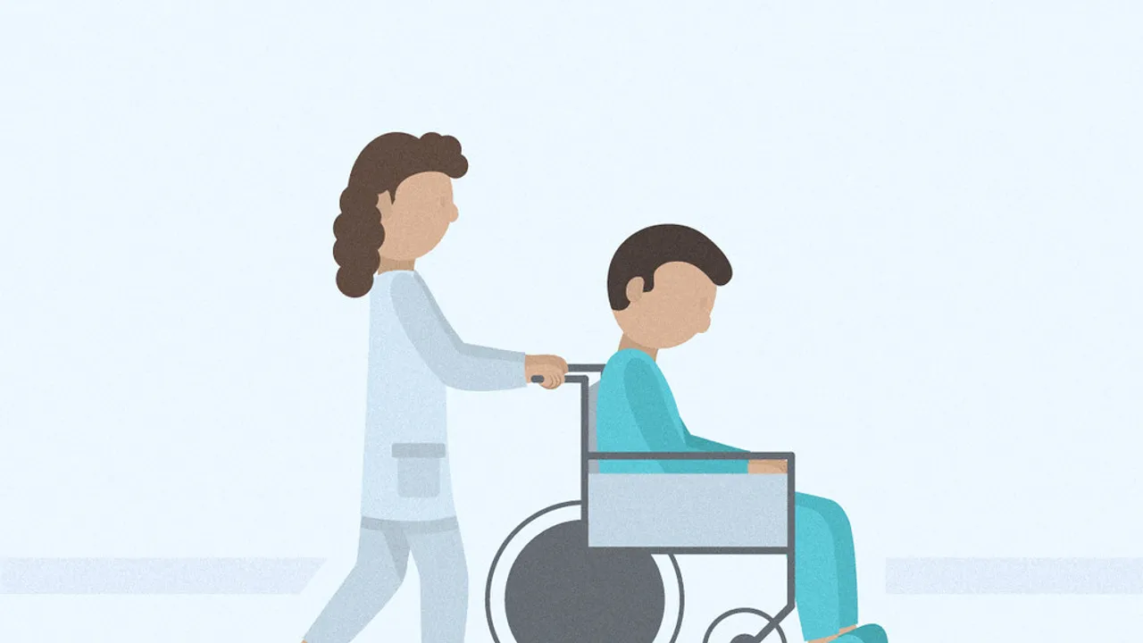 nurse pushing a patient in a wheelchair