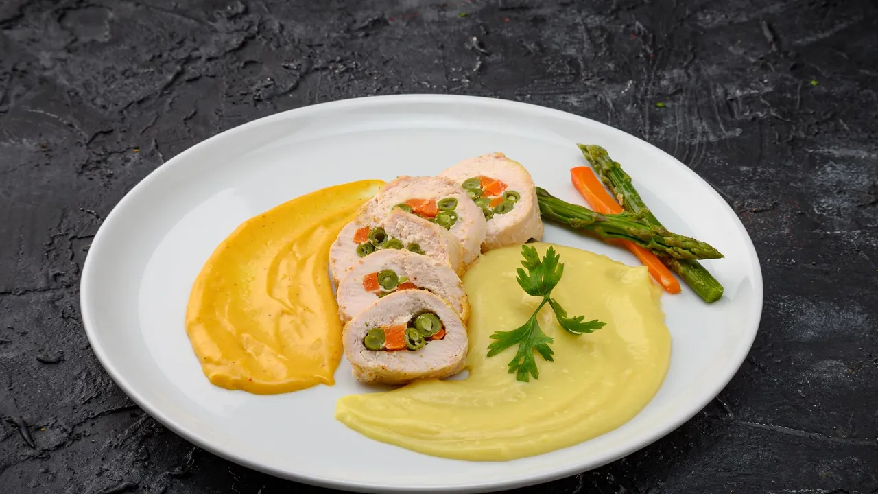 Sliced chicken roulade with vegetable filling served with dual purees and asparagus.
