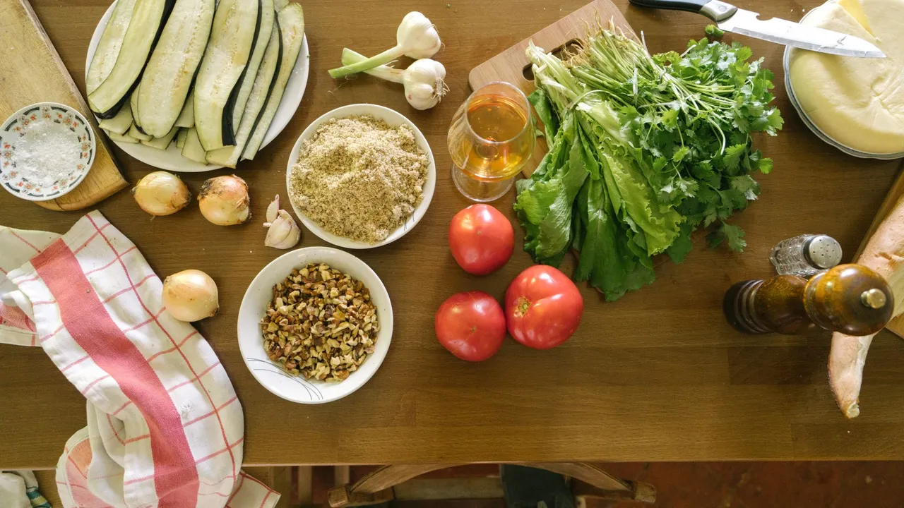 Top view of fresh vegetables and ingredients on a wooden table, ideal for healthy recipes.