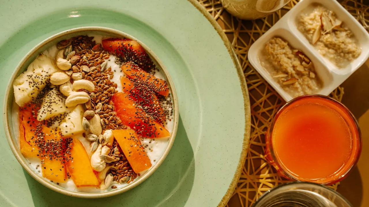 A vibrant breakfast bowl with yogurt, fruits, and seeds, perfect for a healthy morning start.