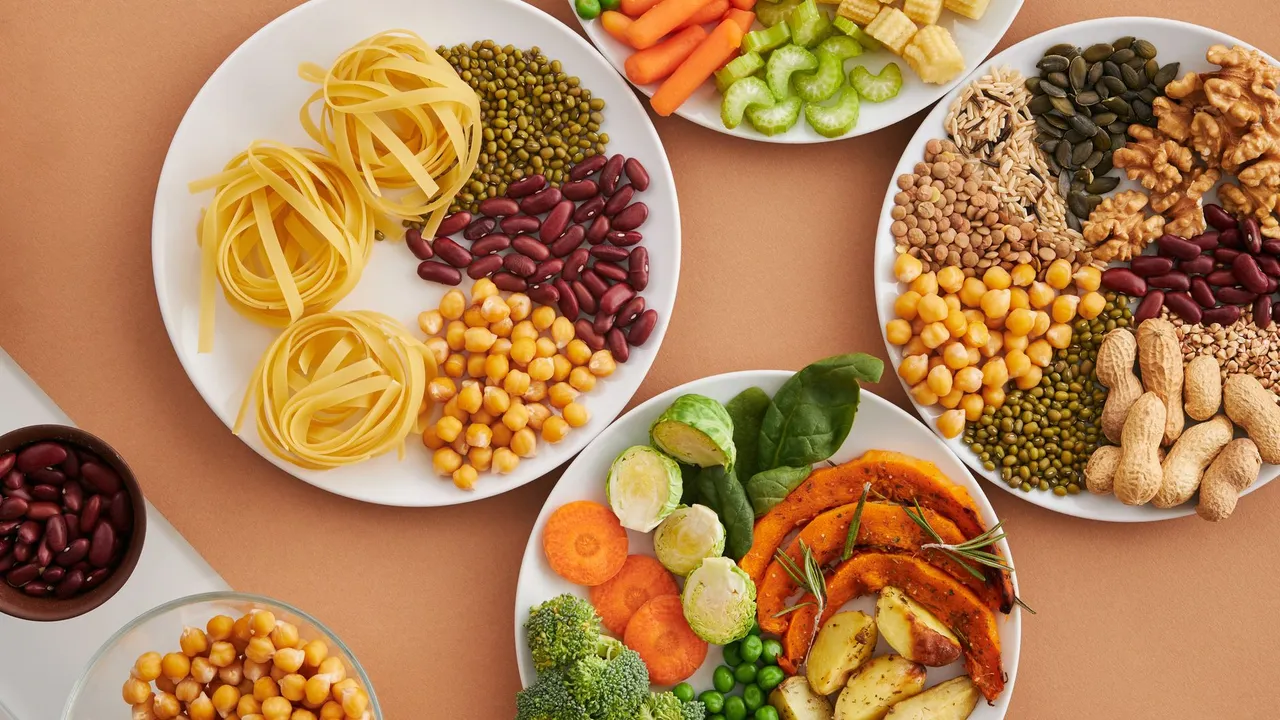 A vibrant mix of legumes, vegetables, nuts, and pasta arranged on white plates showcasing a balanced, healthy diet.