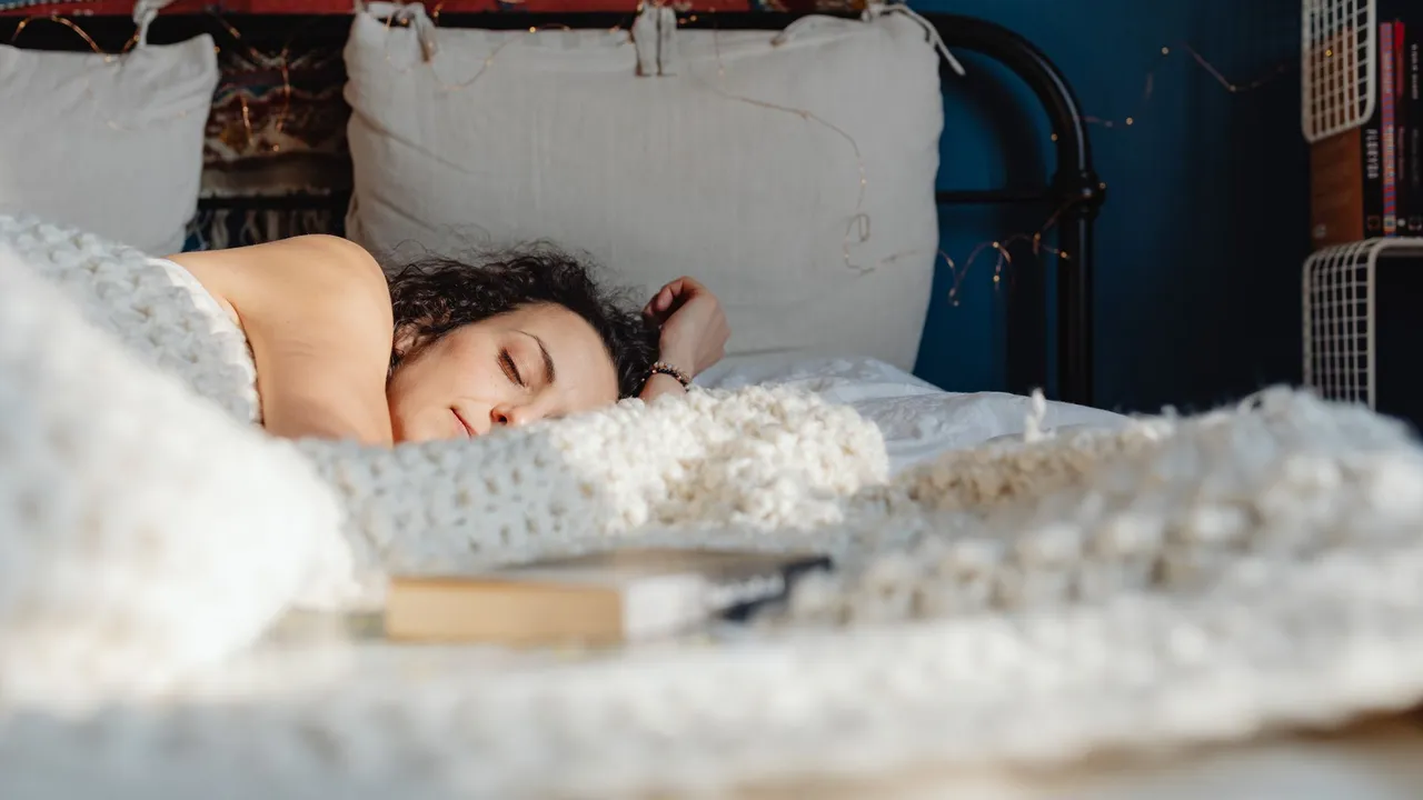 A woman peacefully sleeping on her side in a cozy, sunlit bedroom with decorative elements.