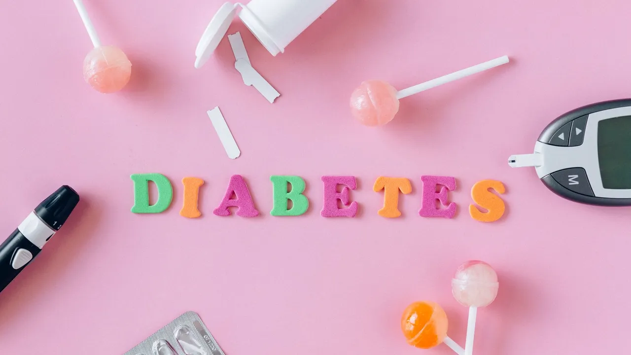 Flat lay image depicting diabetes with glucometer, pills, and lollipops on a pink background.