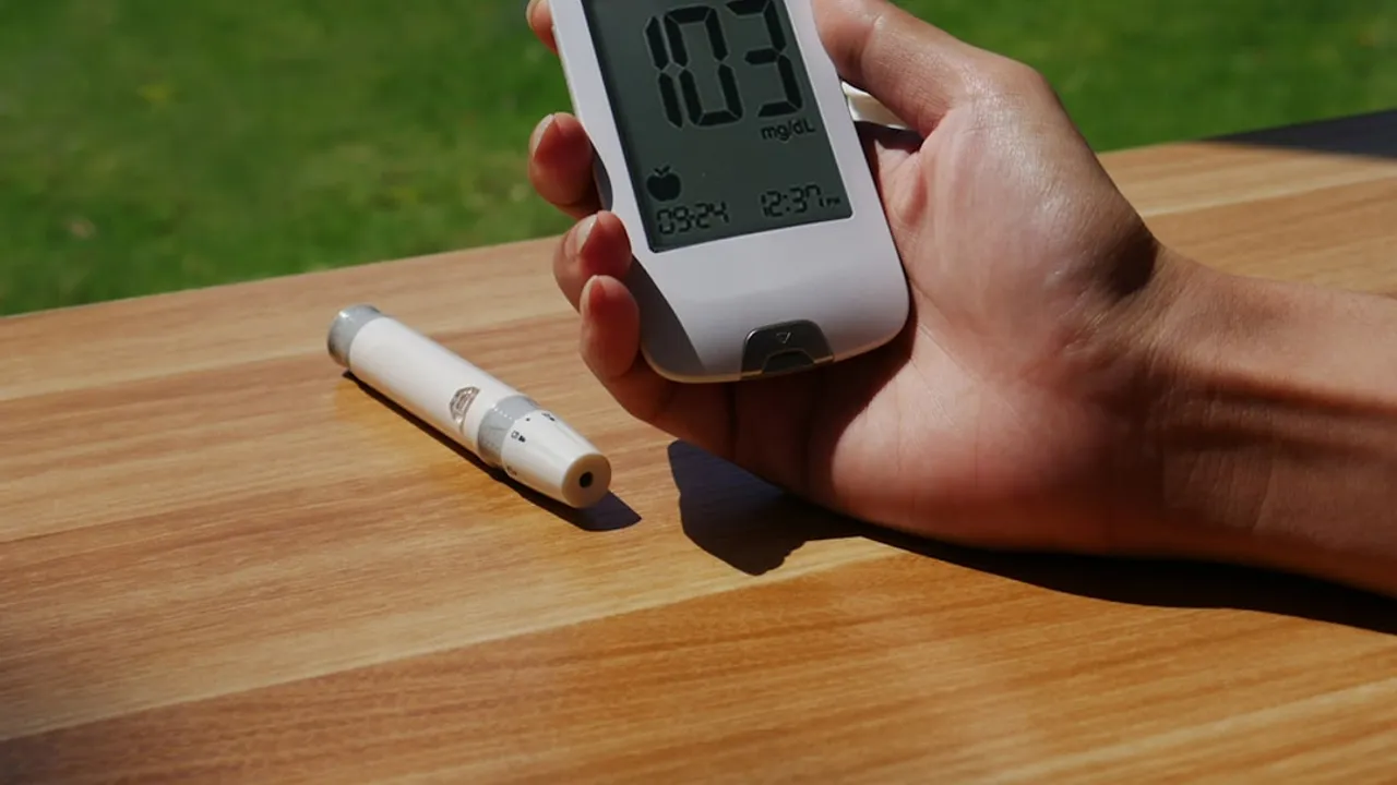 a person holding a cell phone with a thermometer in their hand