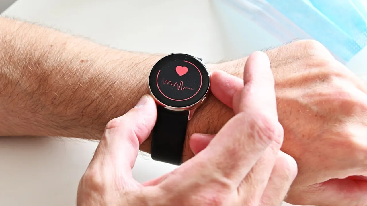 A person checking a heart rate monitor on a smartwatch on their wrist