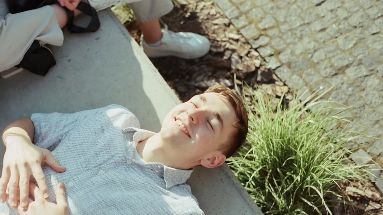 A man laying on the ground next to a woman