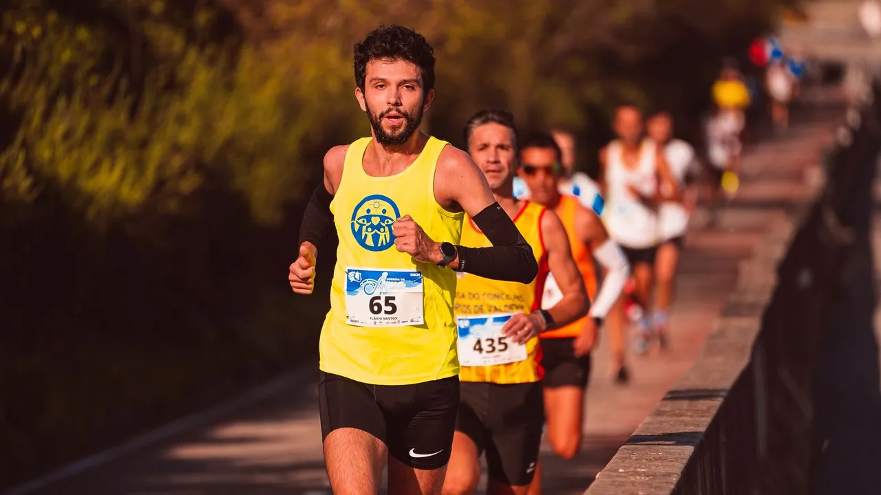 Athletic men running a marathon outdoors on a sunny day.