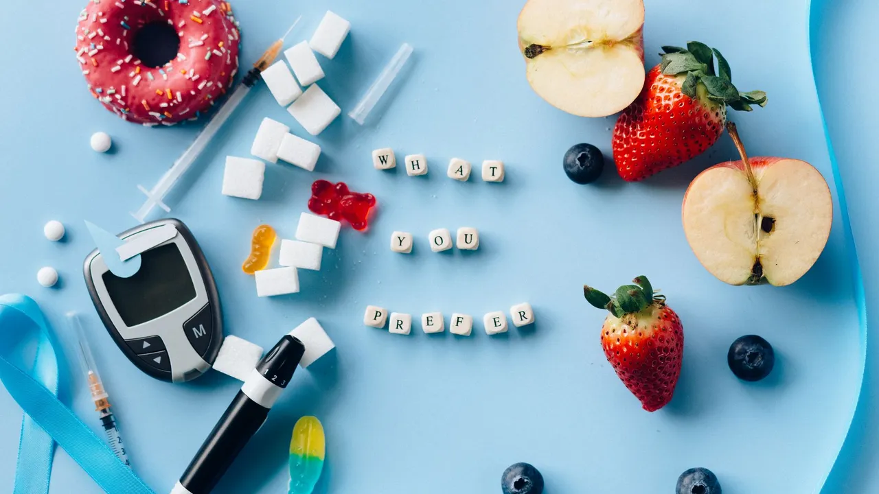 A creative diabetes awareness still life with insulin syringe, fruits, donut, and glucose meter on blue background.